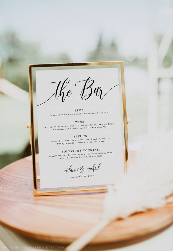 the menu card was placed on top of a wooden plate with a feather in it