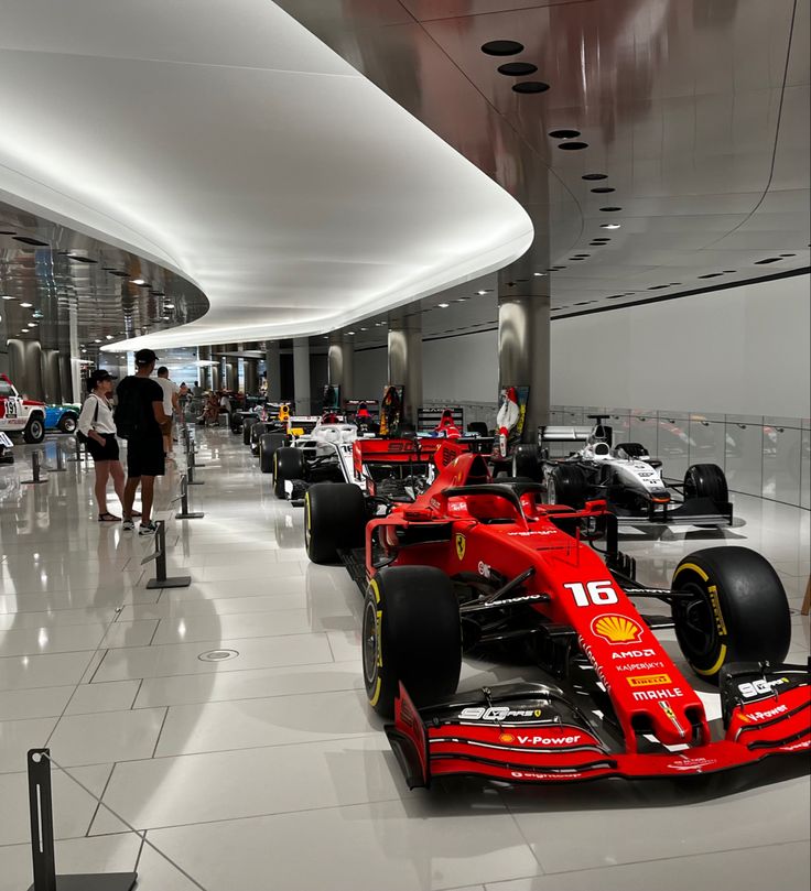 a red race car is on display in the lobby