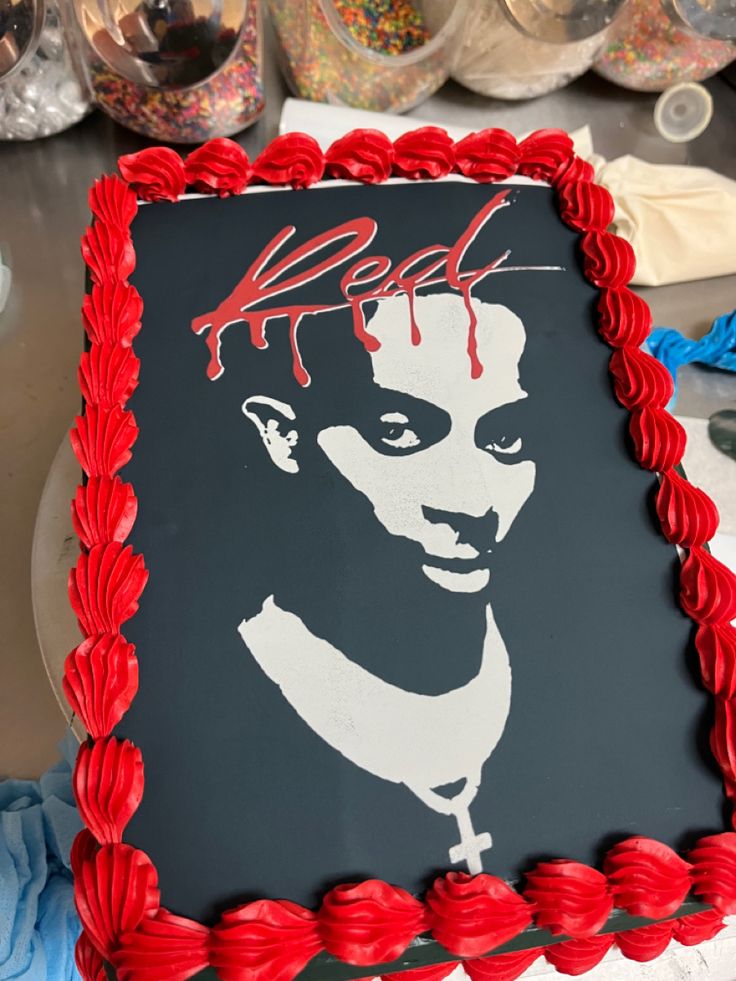 a cake decorated with the image of a woman's face and blood on it