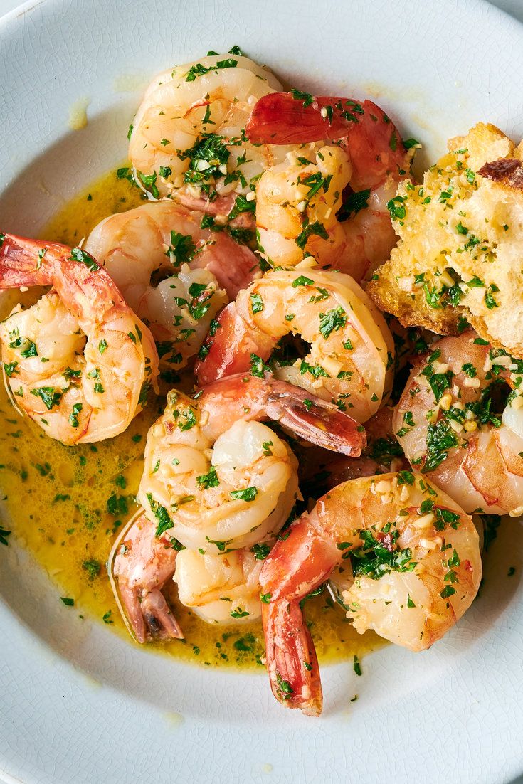 a white plate topped with shrimp and grits