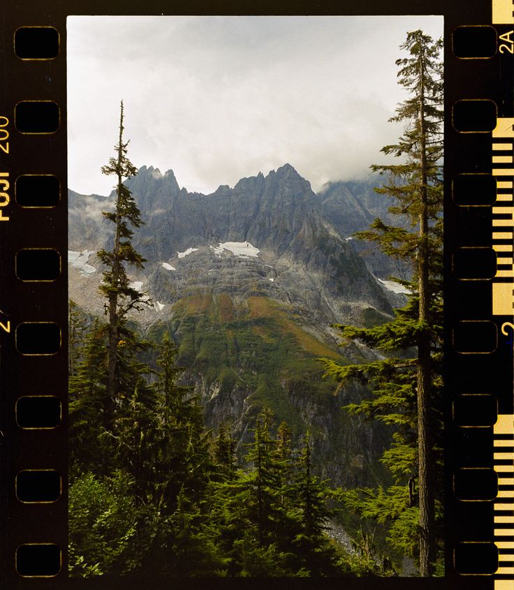 the mountains are covered in snow and trees