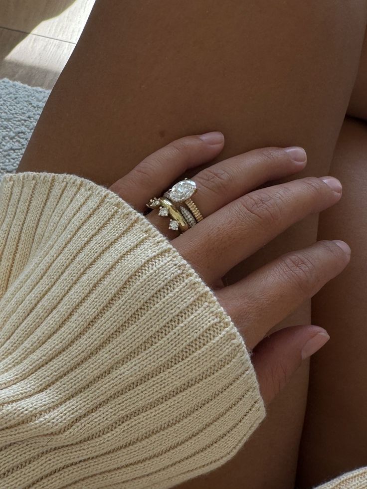 a close up of a person's hand with a ring