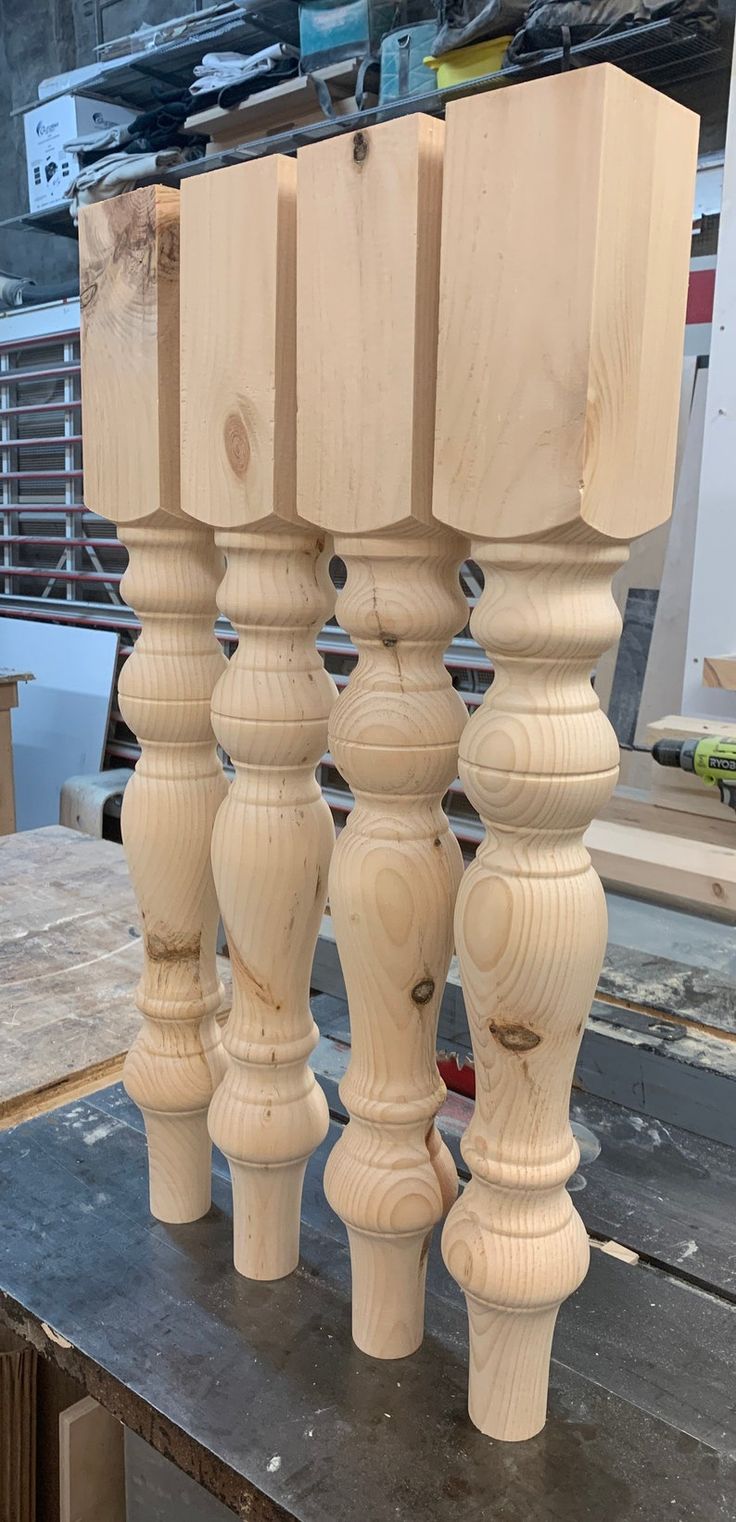 three wooden posts are stacked on top of each other in the process of being made