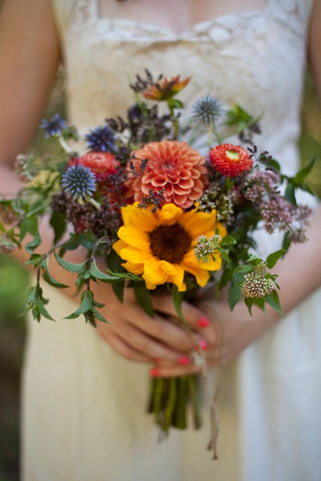 a woman holding a bouquet of flowers in her hands