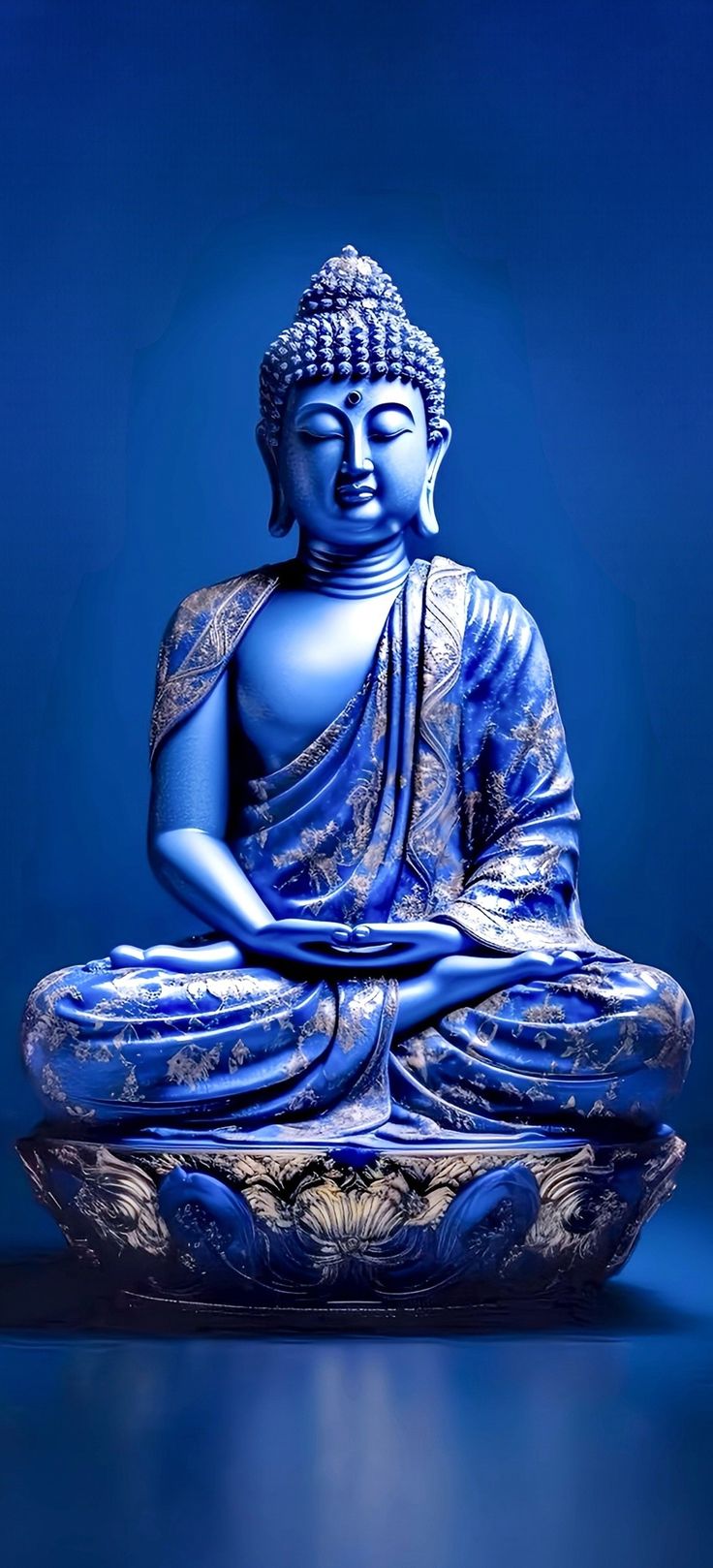 a buddha statue sitting on top of a blue surface