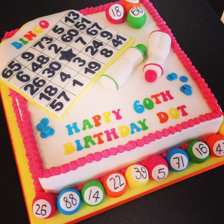 a birthday cake decorated with numbers, abas and a sud puzzle on the side