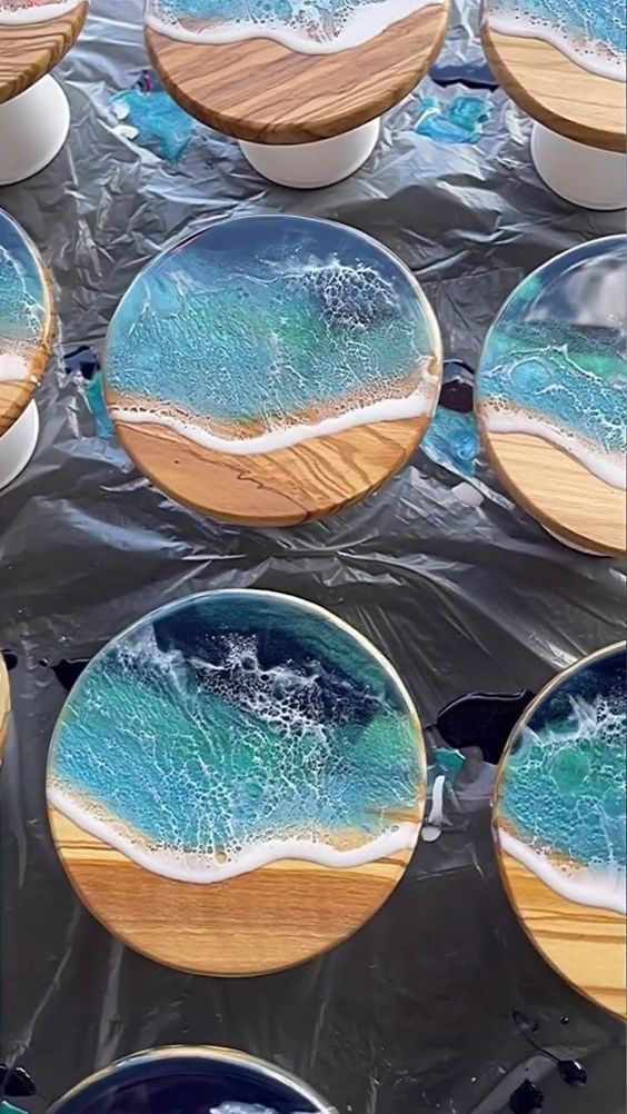 several plates with blue and green designs on them sitting in the middle of some tin foil