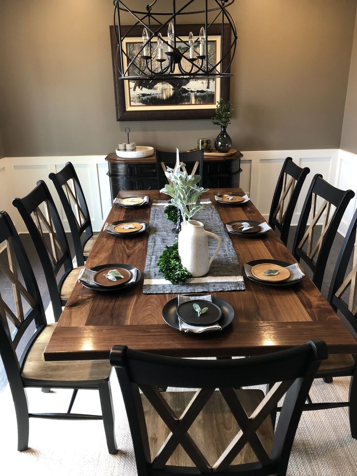 a dining room table set with plates and place settings for six people to sit at