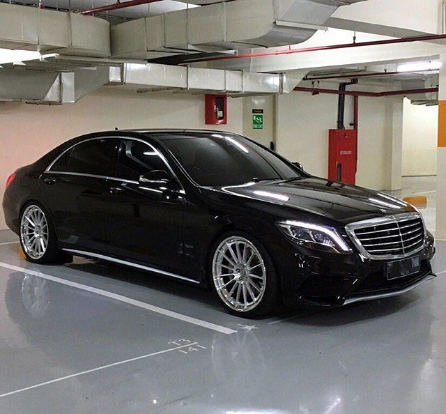 a black car parked in a parking garage