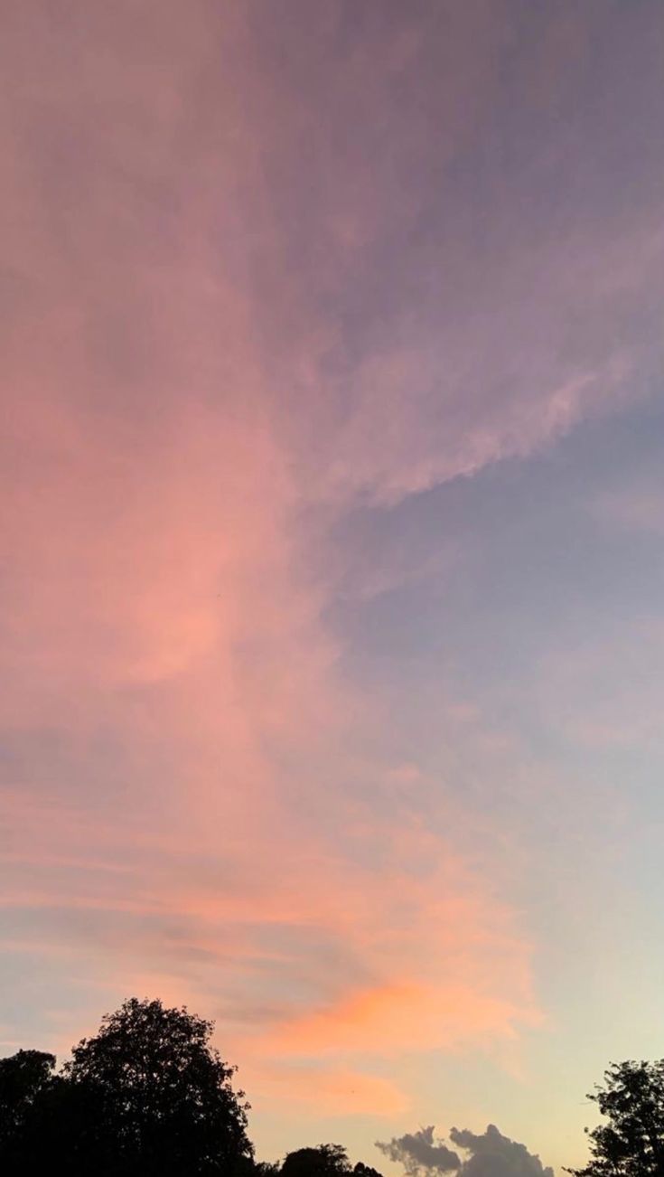 the sky is pink and blue at sunset