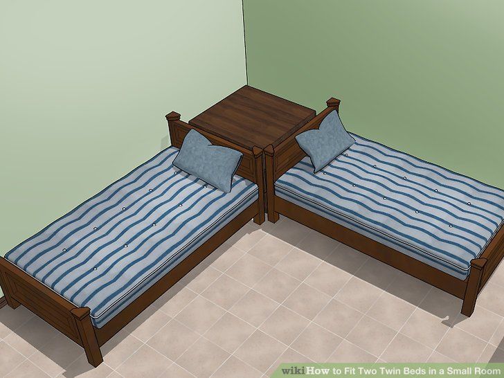 two twin beds in a room with green walls and tile flooring, one is made out of wood