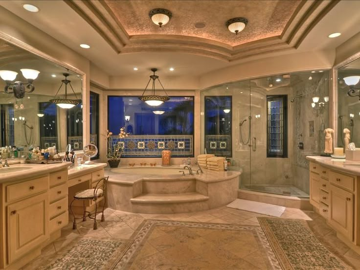 a large bathroom with two sinks and a bathtub in the middle of the room