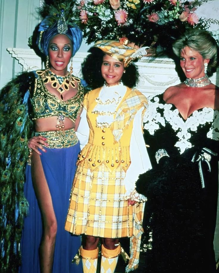 three women in costume posing for a photo