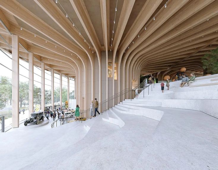 people are walking up and down the stairs in a large building with wooden columns on both sides