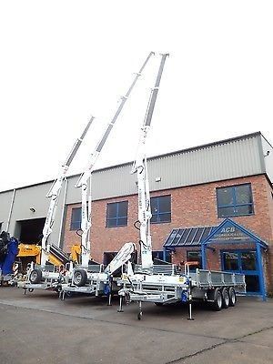 two cranes are parked in front of a building