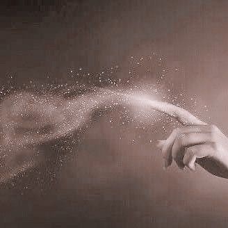 a woman's hand is sprinkled with white powder as she holds out her arm