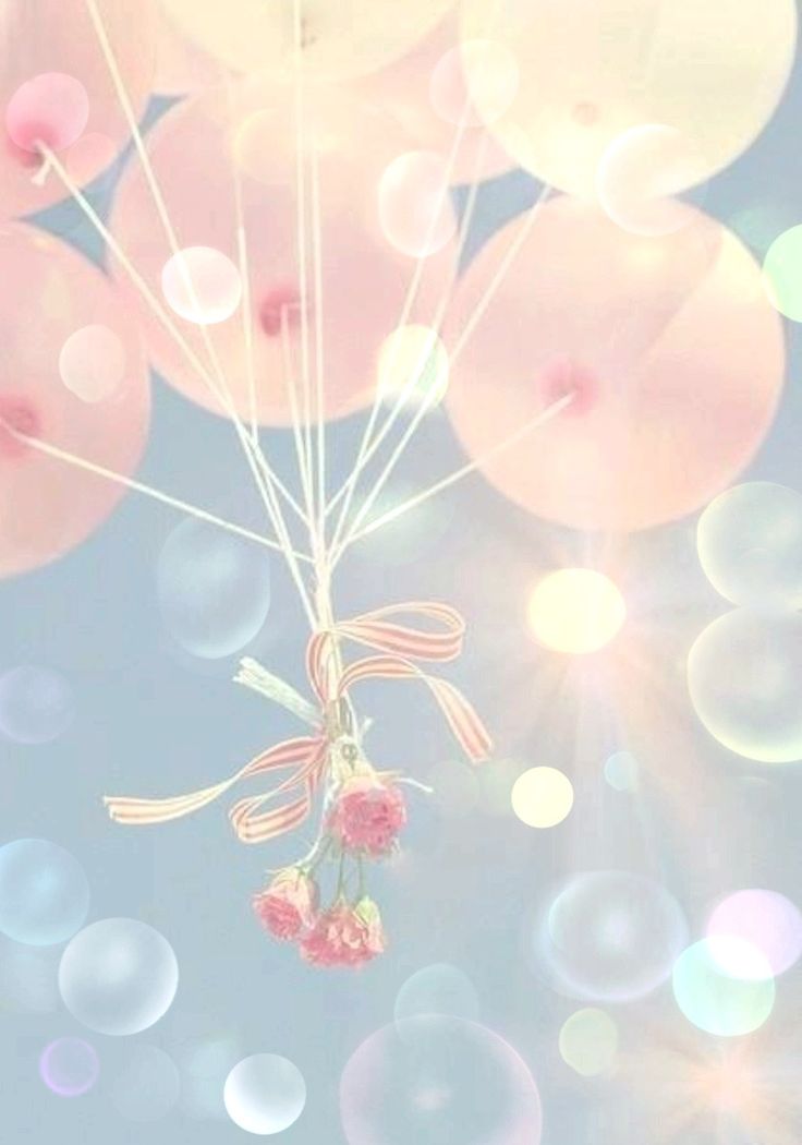 a bunch of balloons floating in the air with some pink flowers on top of them