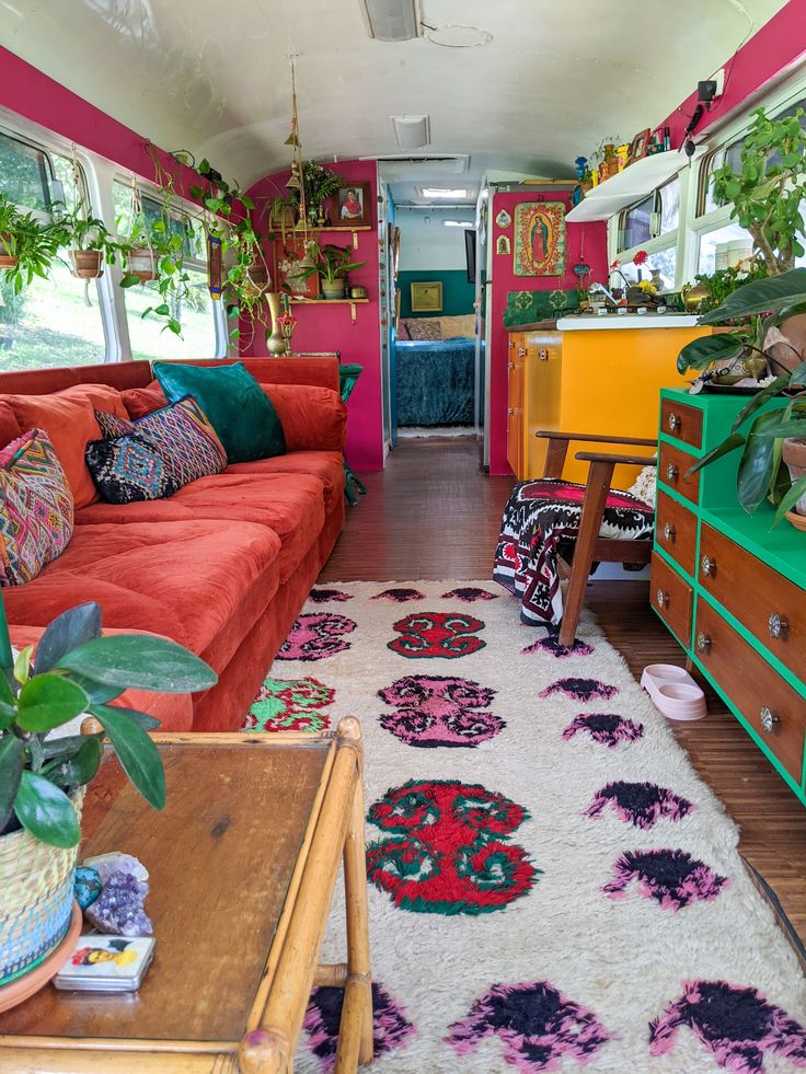 a living room filled with furniture and lots of plants