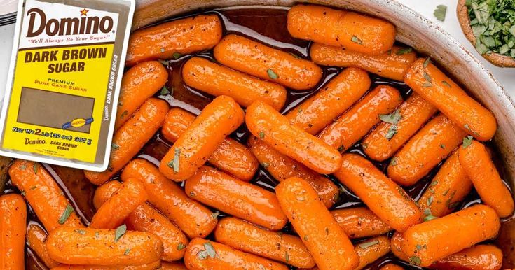 there are many carrots that have been cooked in the pot with sauce on it