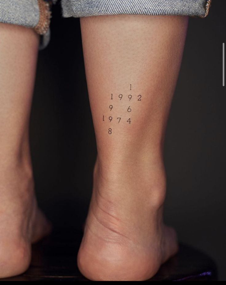 two people with numbers tattooed on their legs