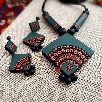 three pieces of jewelry sitting on top of a table