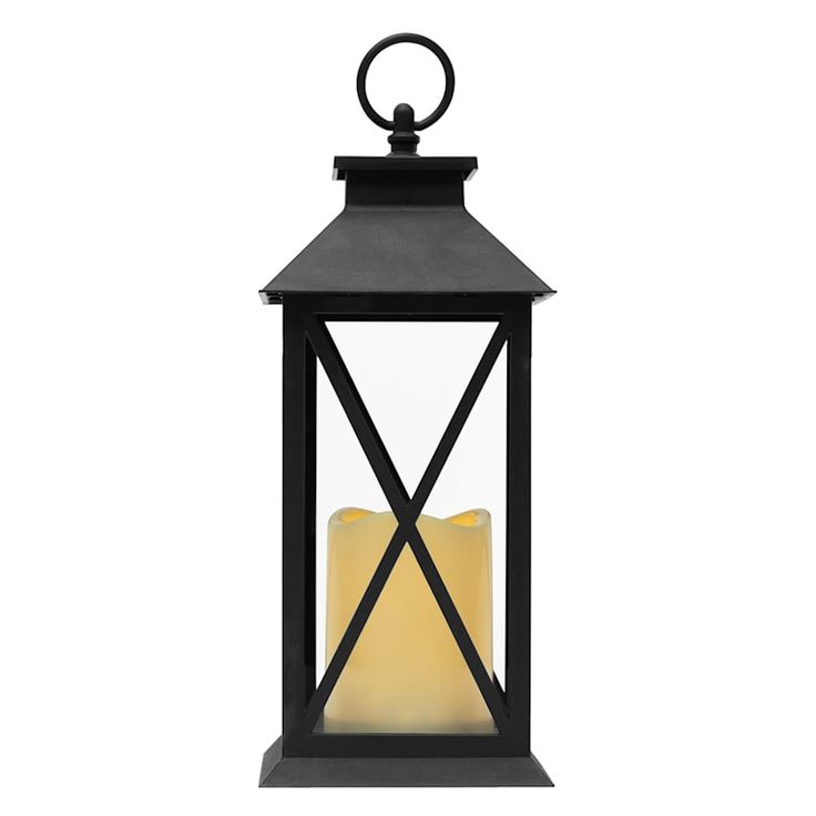 a black lantern with a yellow candle in the center on an isolated white background photo