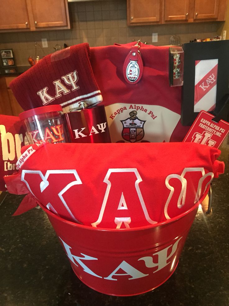 a red bucket filled with items on top of a counter