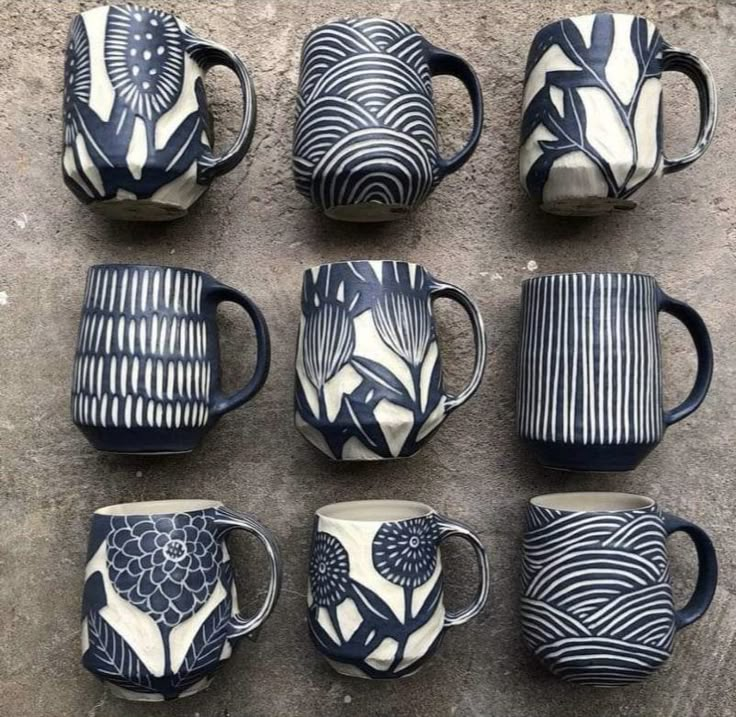 nine coffee mugs are sitting on the ground