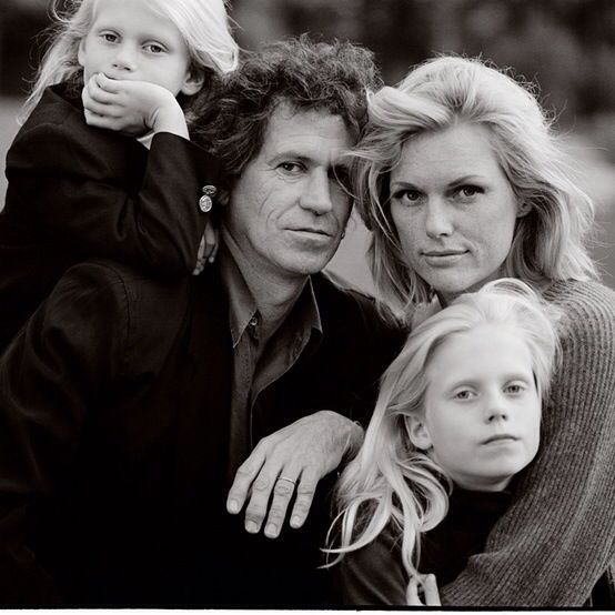 two women and a child are posing for the camera