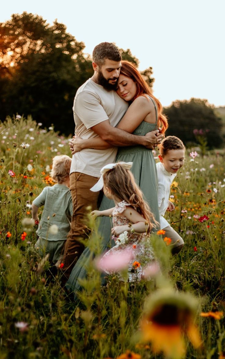 a man hugging a woman in a field full of flowers