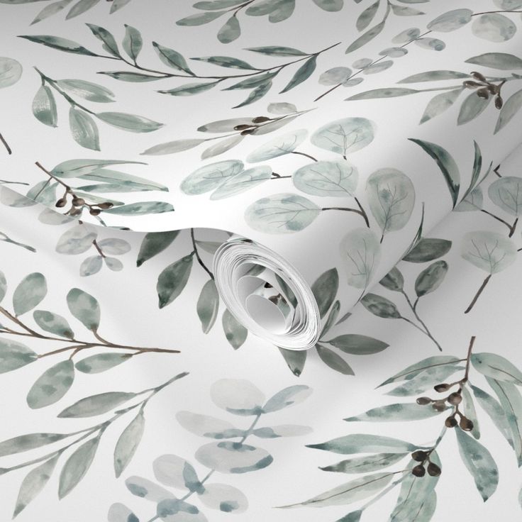 a white wallpaper with green leaves on it