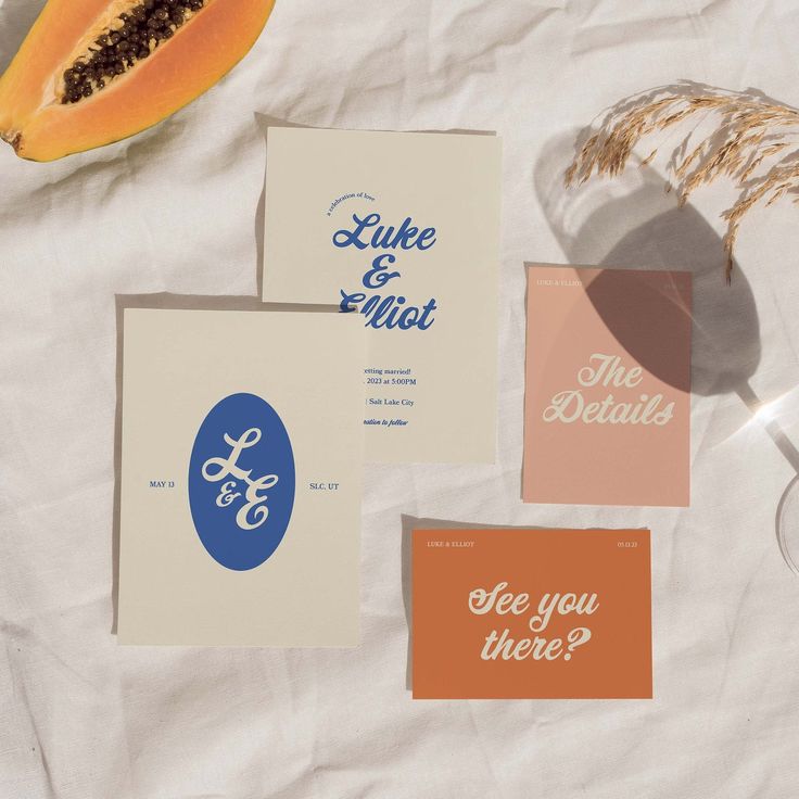 some cards that are laying on top of a white table cloth and one has a slice of papaya