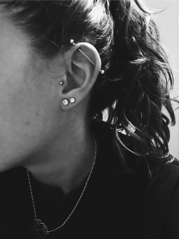 black and white photograph of woman with ear piercings