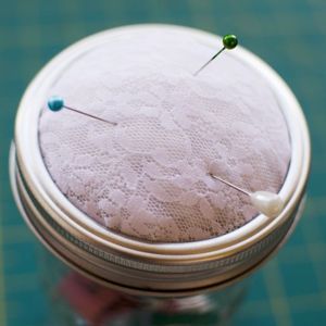 a close up of a sewing needle in a jar