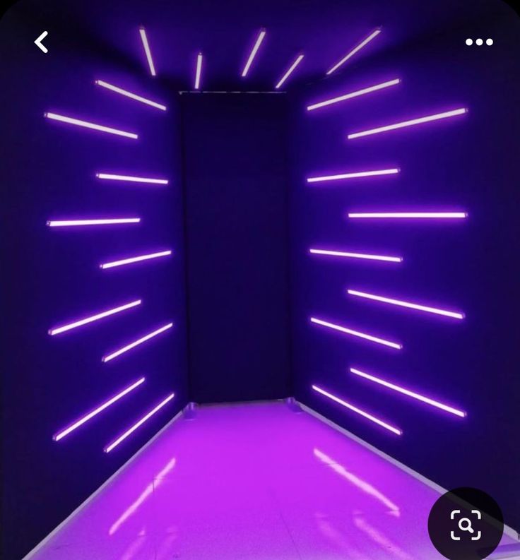 an empty room with purple lights in the middle and white flooring on the other side