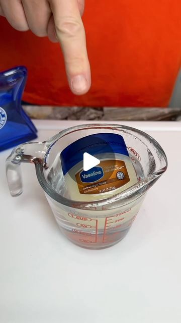 a person is measuring something in a measuring cup