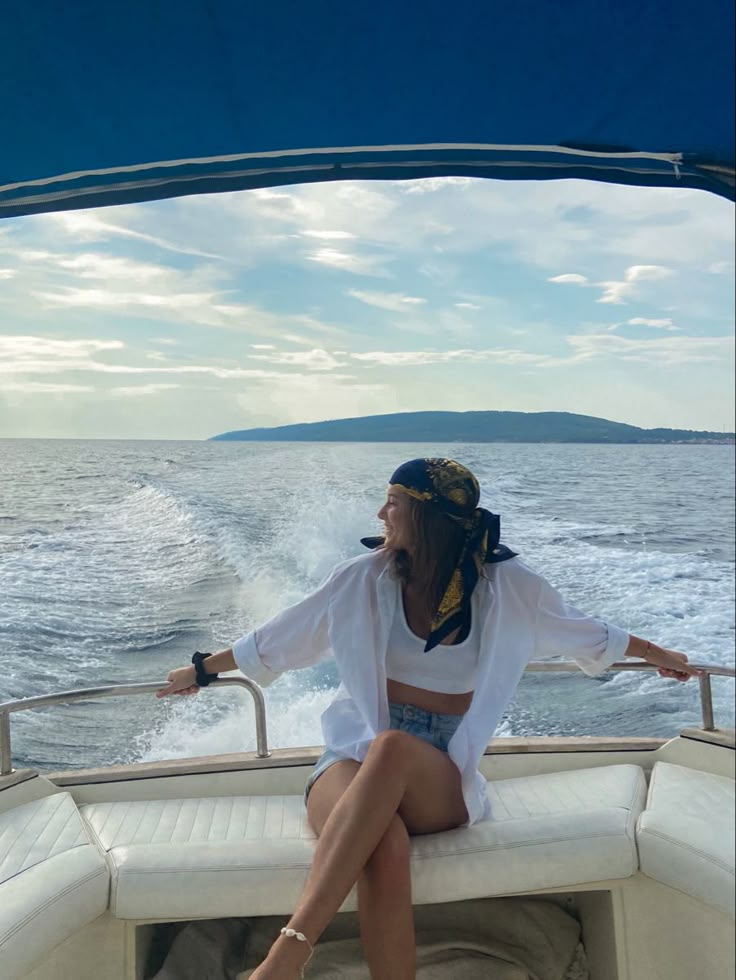 a woman sitting on the back of a boat