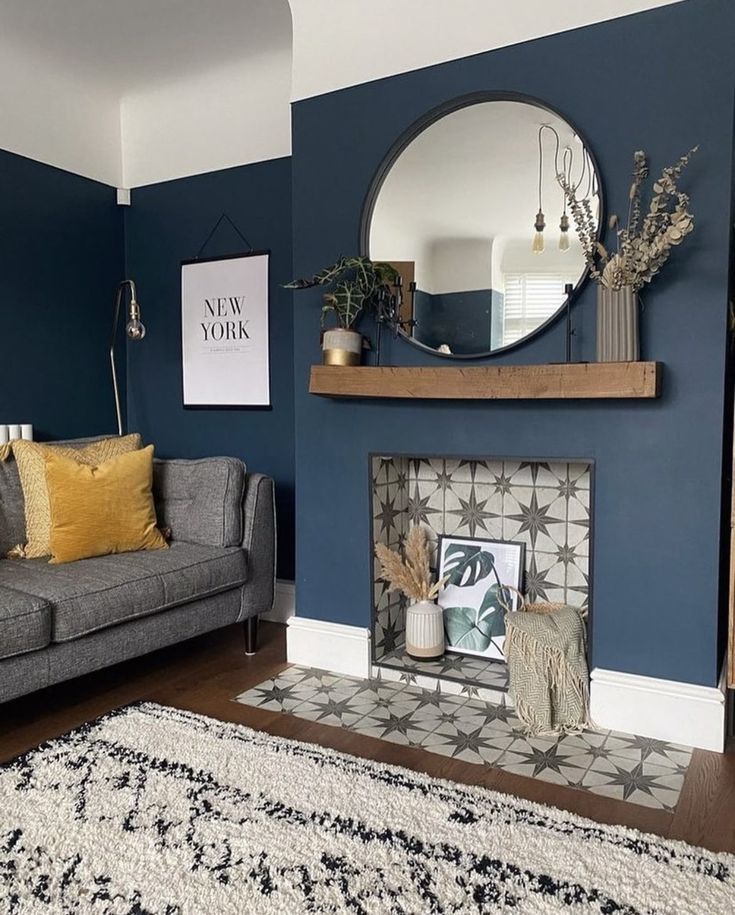 a living room with blue walls and white rugs on top of the carpeted floor