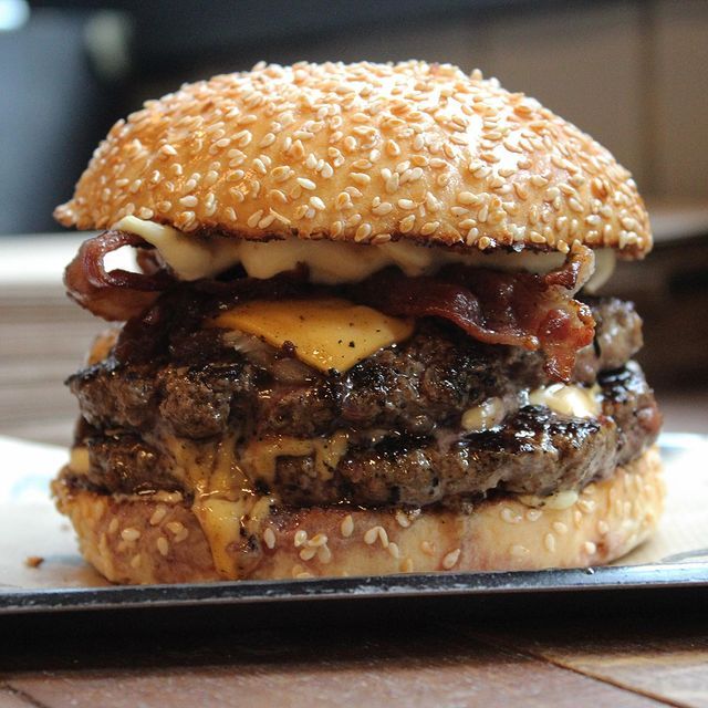 a hamburger with cheese and bacon on it