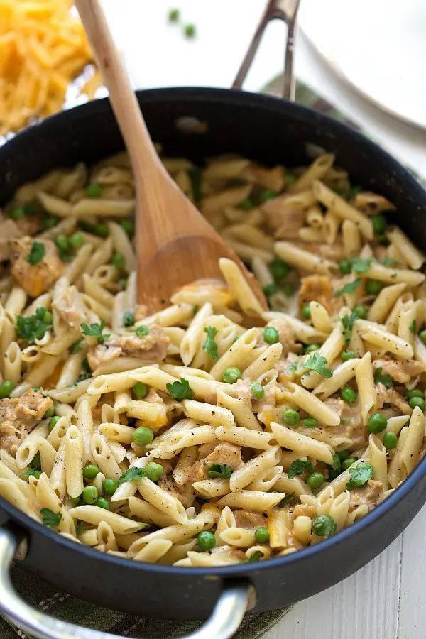 a skillet filled with pasta and peas