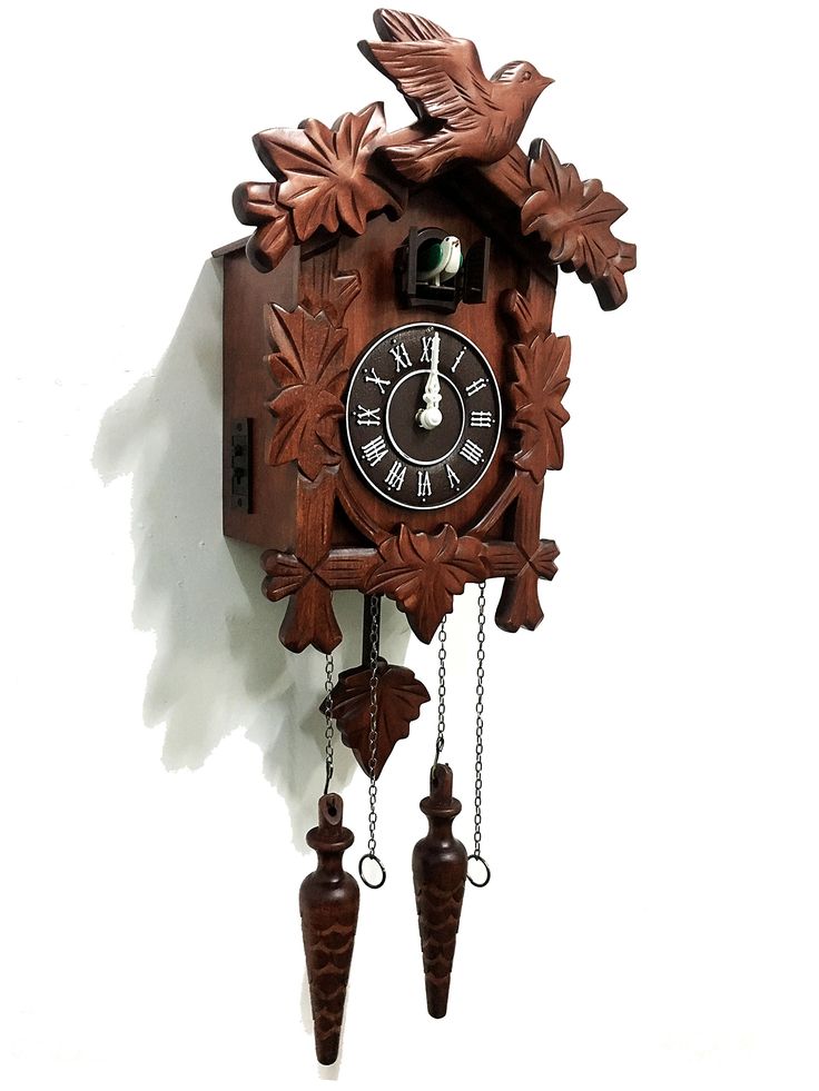 a wooden cuckoo clock hanging on the wall