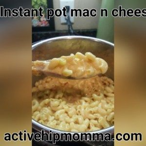 a ladle full of macaroni and cheese being lifted from a pot with the words instant pot mac n cheese