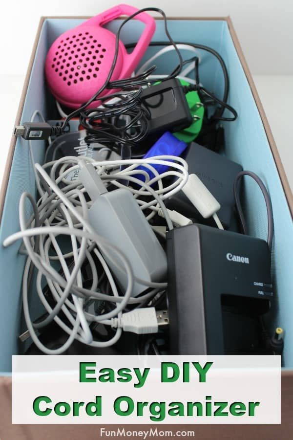 an open box with cords and other electronic items in it that says easy diy cord organizer