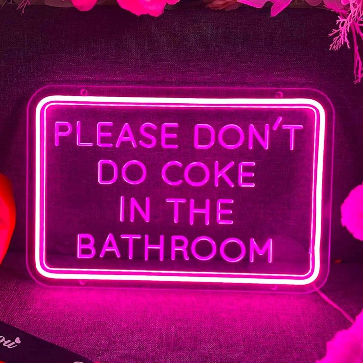 a neon sign that says, please don't do cake in the bath room