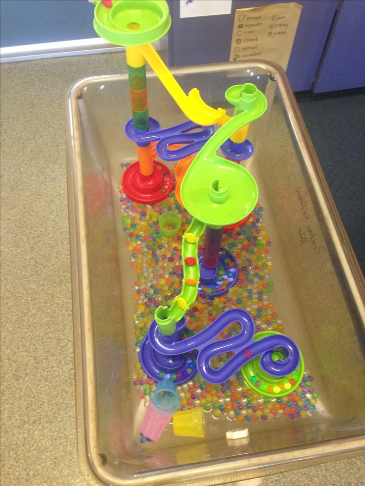 a plastic tray filled with toys on top of a table