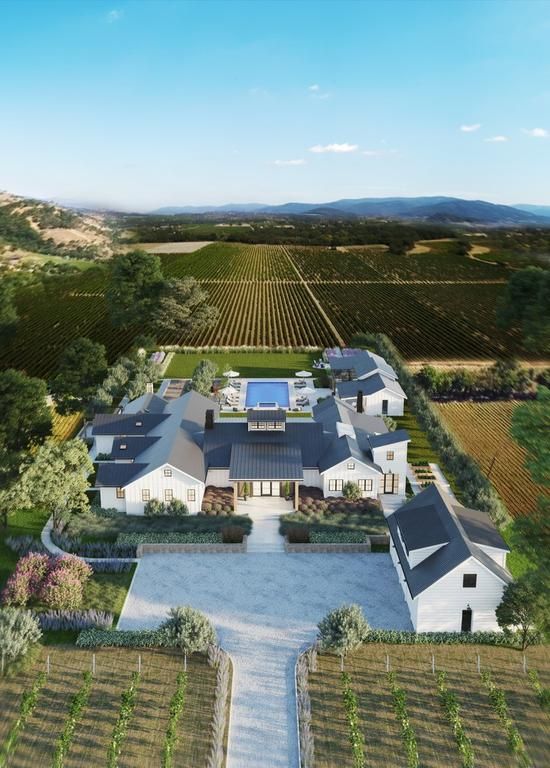 an aerial view of a large house in the middle of a field with lots of trees