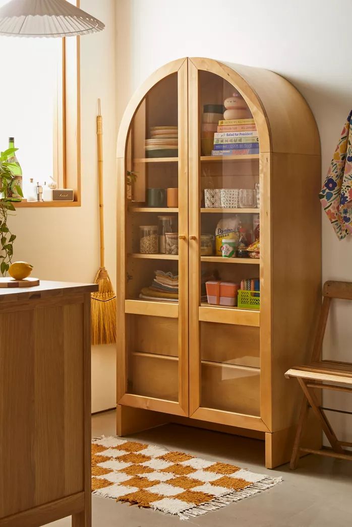 a wooden cabinet with glass doors in a room