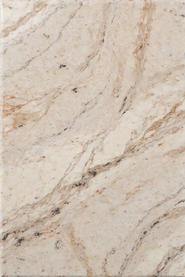 a white marble counter top with brown veining