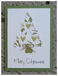 a christmas card with green and white hearts on it, tied to a ribbon in the shape of a tree