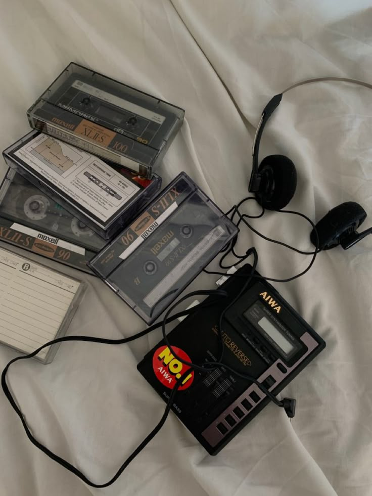 there are cassettes and headphones on the bed